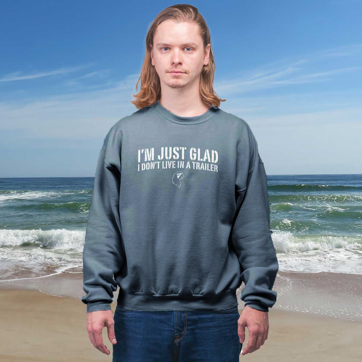 Person wearing a sweatshirt with text on a beach