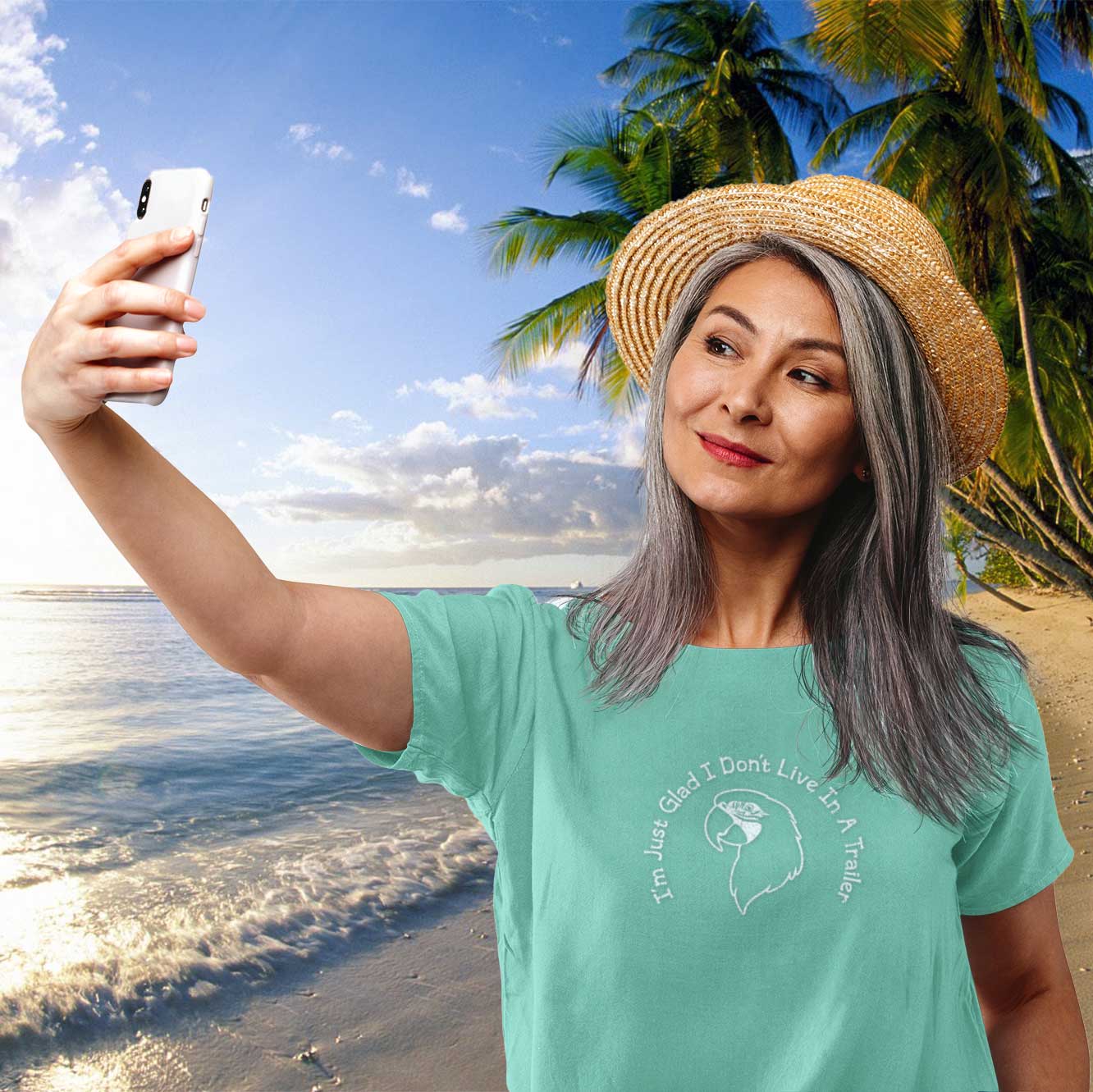 Woman taking a selfie on a beach with palm trees in the background
