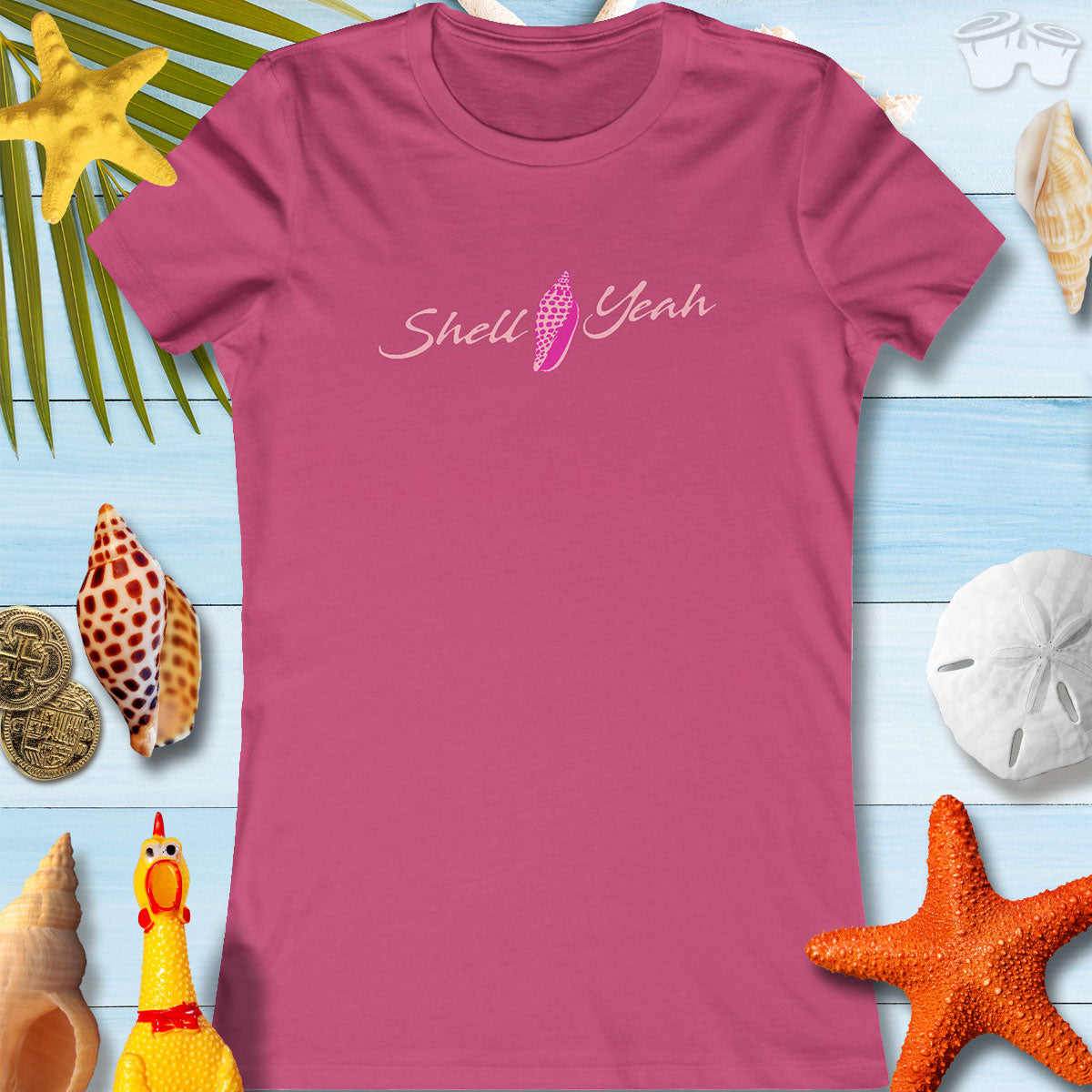 Women's pink t-shirt with 'Shell Yeah' graphic, perfect for beach lovers and summer outings.
