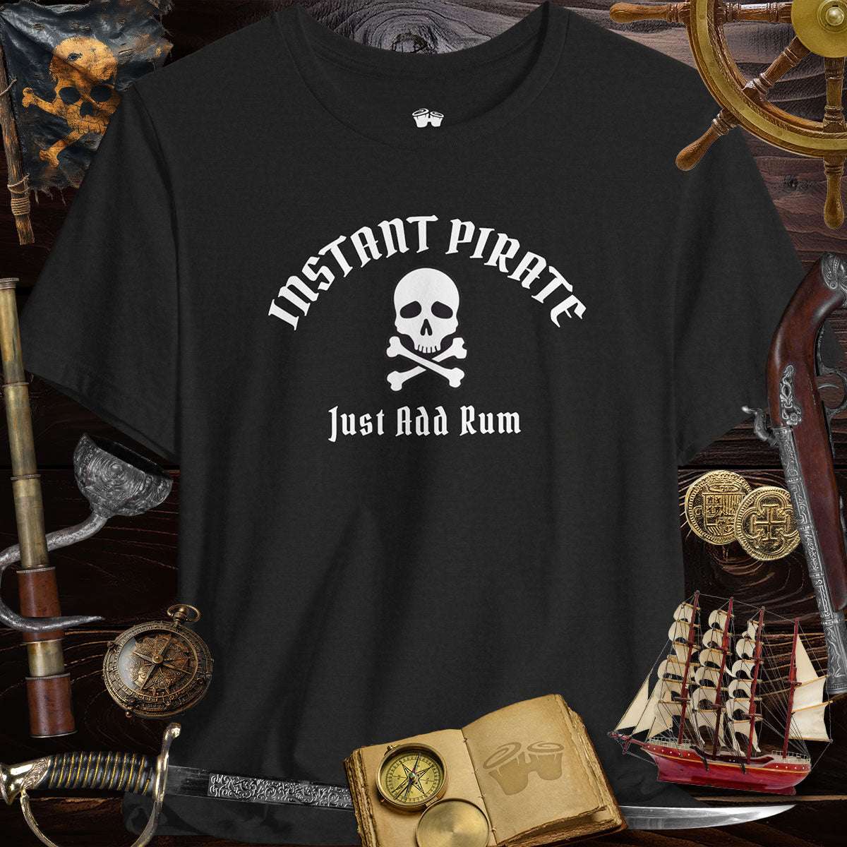 Instant Pirate Just Add Rum Unisex Bella Canvas Tee Shirt on a black background with pirate themed decorations.