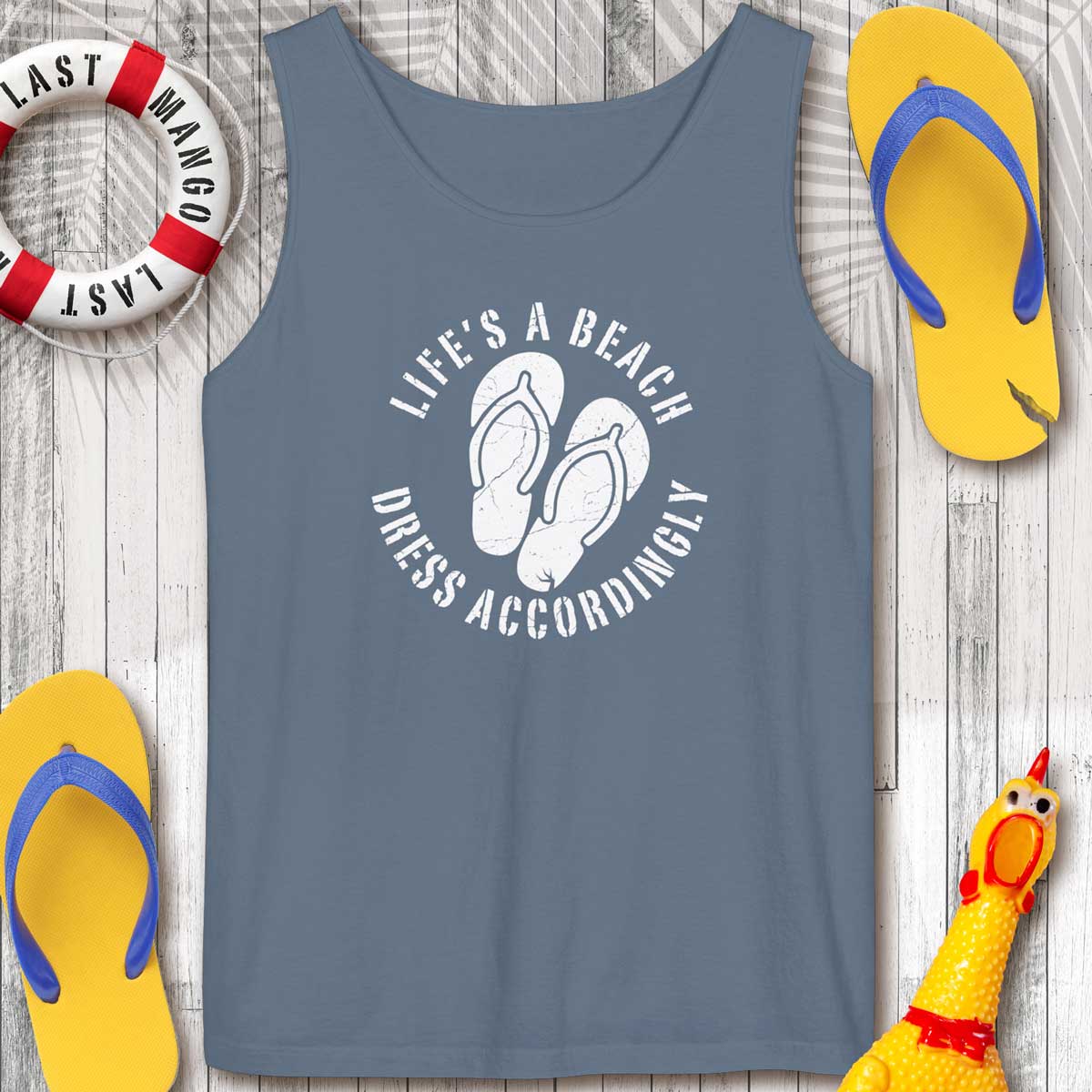 Blue Jean Color tank top with 'Life's a Beach Dress Accordingly' text and flip-flops on a wooden surface
