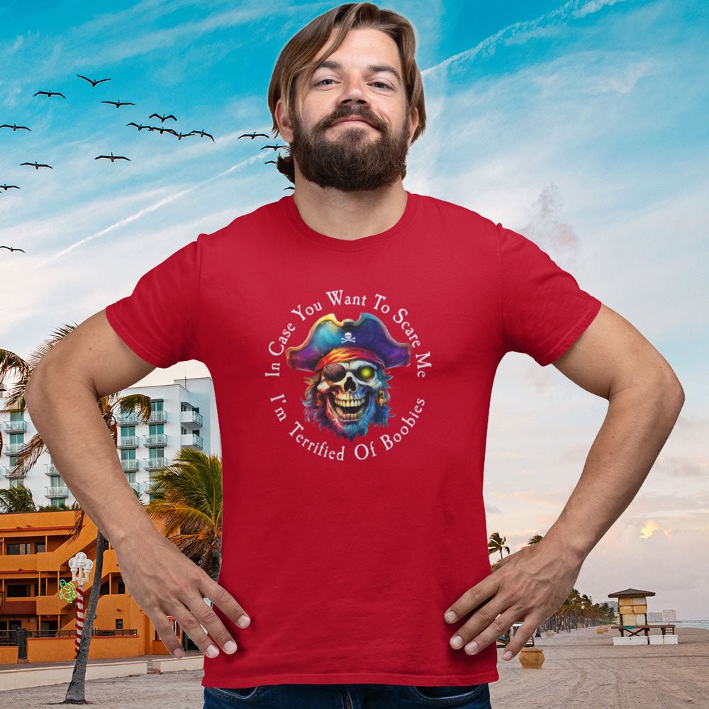 Man wearing a red t-shirt with a colorful graphic design on a beach background