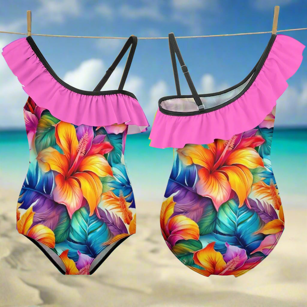 Girls Hawaiian style ruffled one piece swimsuits showing front and back hanging on a line in an island beach paradise