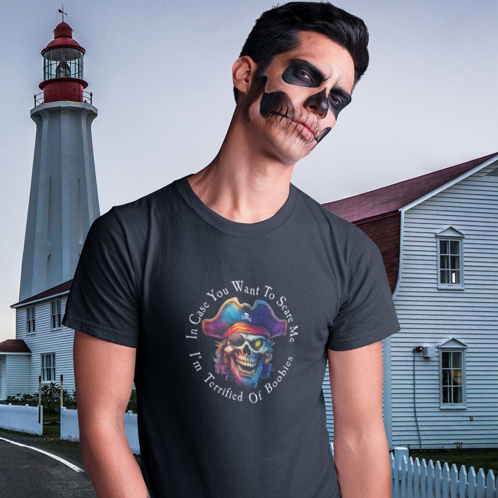 Person wearing a black t-shirt with a colorful graphic design in front of a lighthouse.