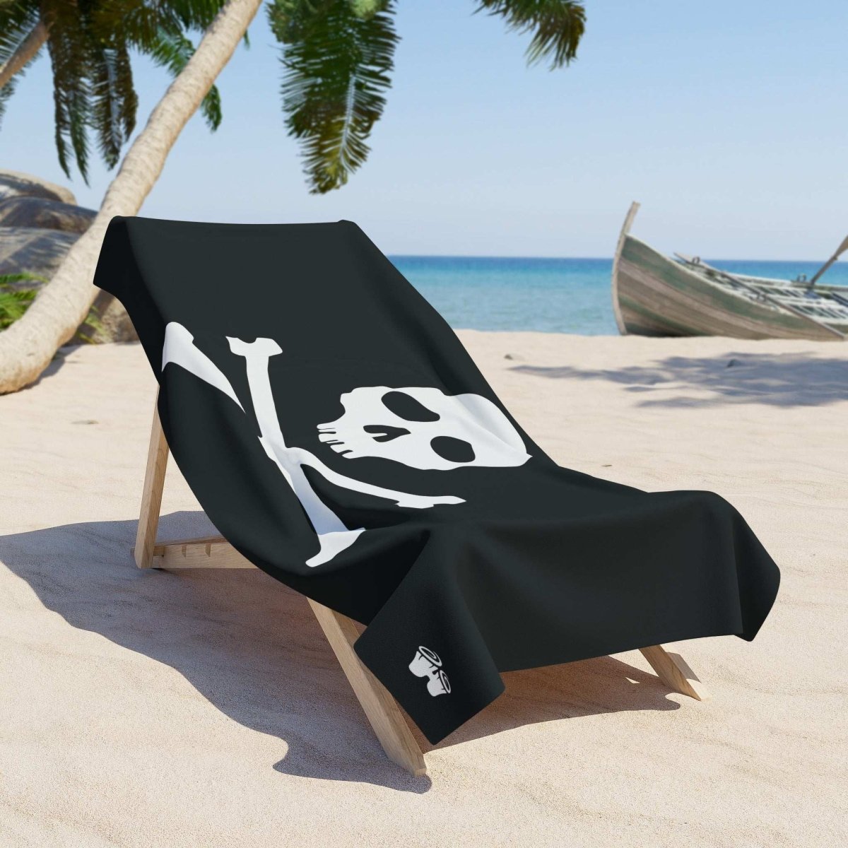 Jolly Roger Pirate Flag Beach Towel draped over a sun lounger on a sandy beach with palm trees and ocean backdrop.