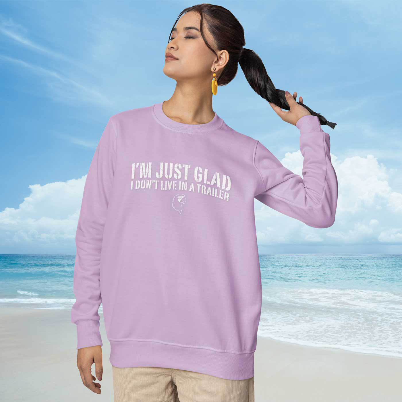 Woman wearing a pink sweatshirt with text on a beach