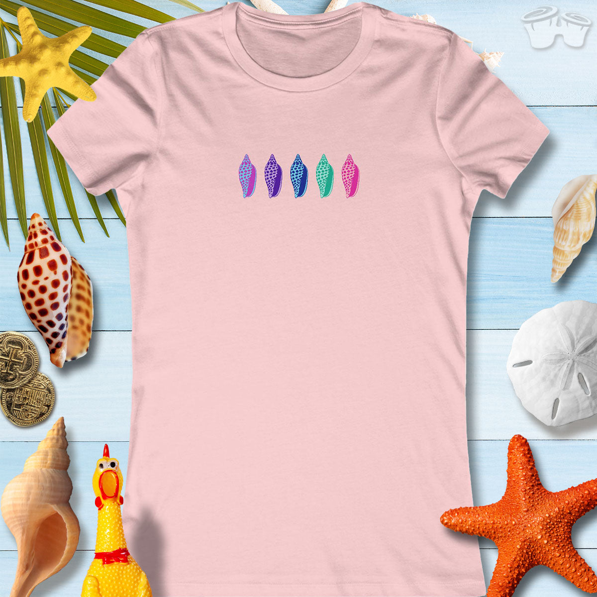 Colorful Junonia seashell design on a pink women's tee, perfect for beach outings and casual summer wear.