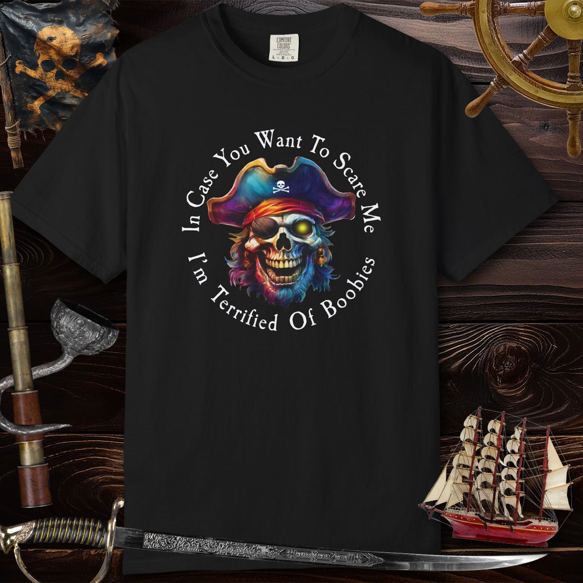 Black t-shirt with a colorful pirate skull design and text on a wooden background with ship and sword.