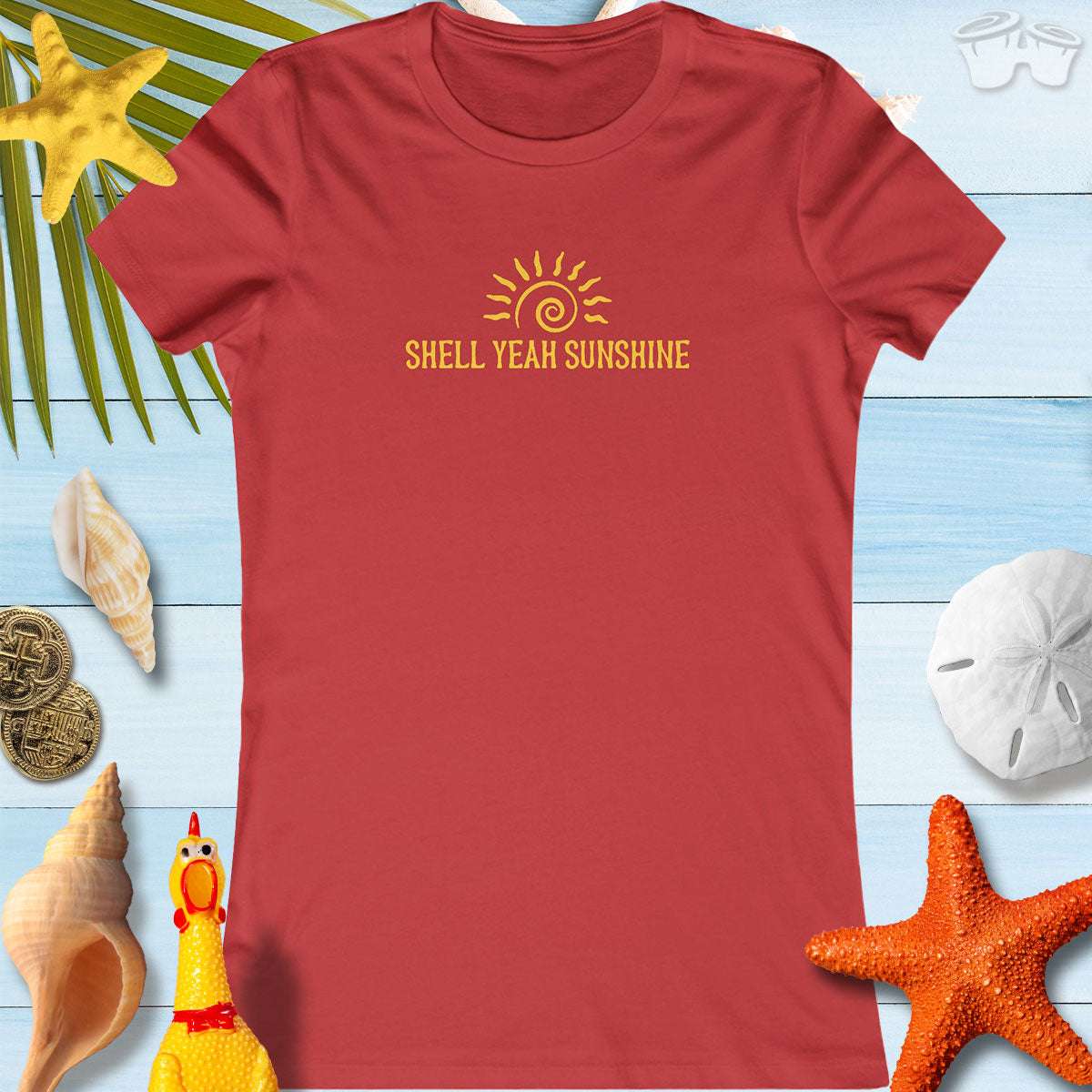 SHELL YEAH SUNSHINE women's summer t-shirt in vibrant red against beach-themed backdrop, perfect for sunny outings.