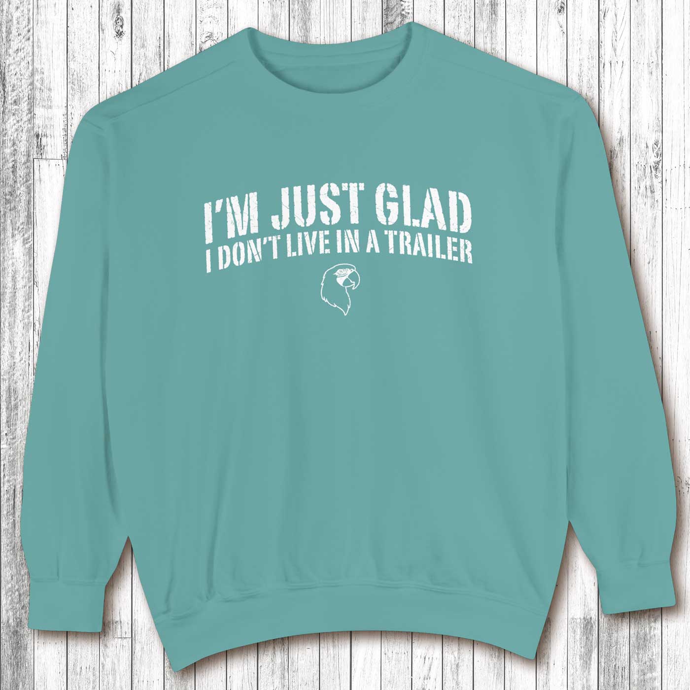 Teal sweatshirt with text on a wooden background