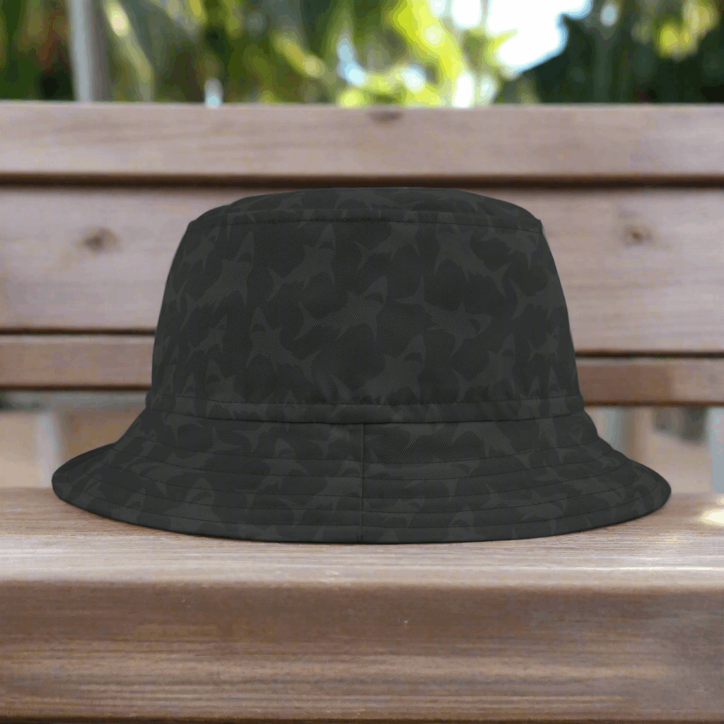 Back Bucket hat with subtle shark pattern sitting on a park bench in Key West