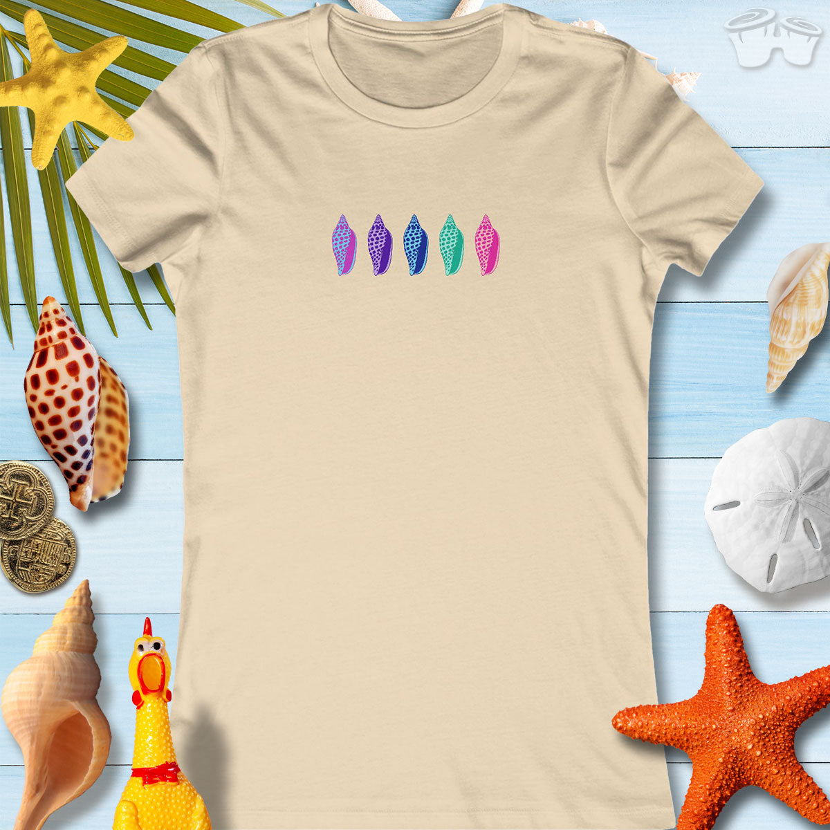 Colorful Junonia seashells design on a beige tee for women, perfect for beach outings and casual wear.
