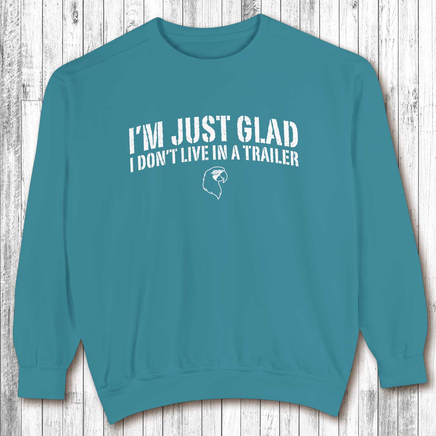 Teal sweatshirt with white text on a wooden background