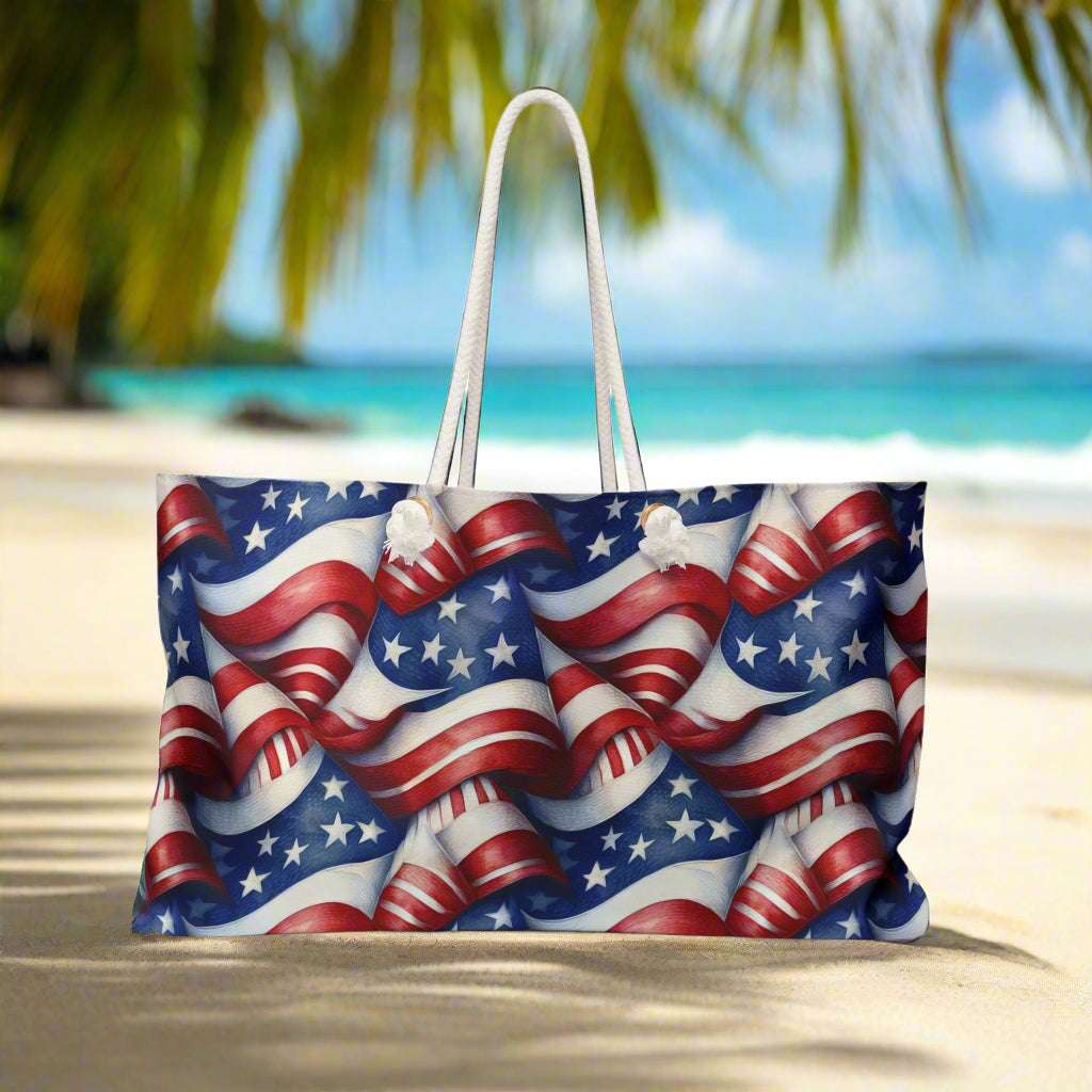 Oversized tote back featuring USA flag pattern sitting on a beach in a tropical paradise