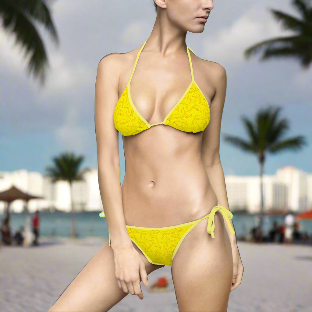 Hot Yellow Bikini with cool dolphin patten in miami team orange on swimwear model standing on miami beach