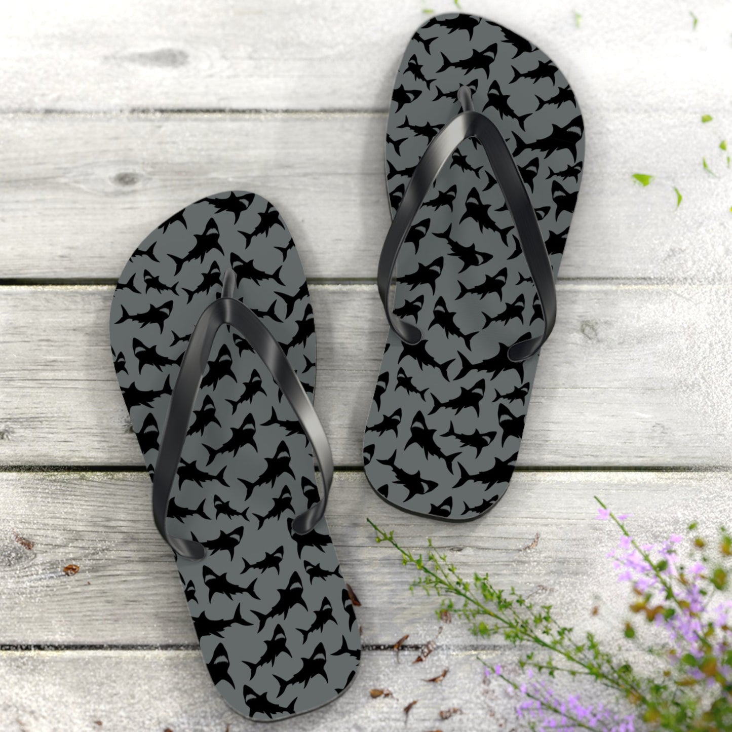 Flip-flops with black pattern on gray nautical wood background