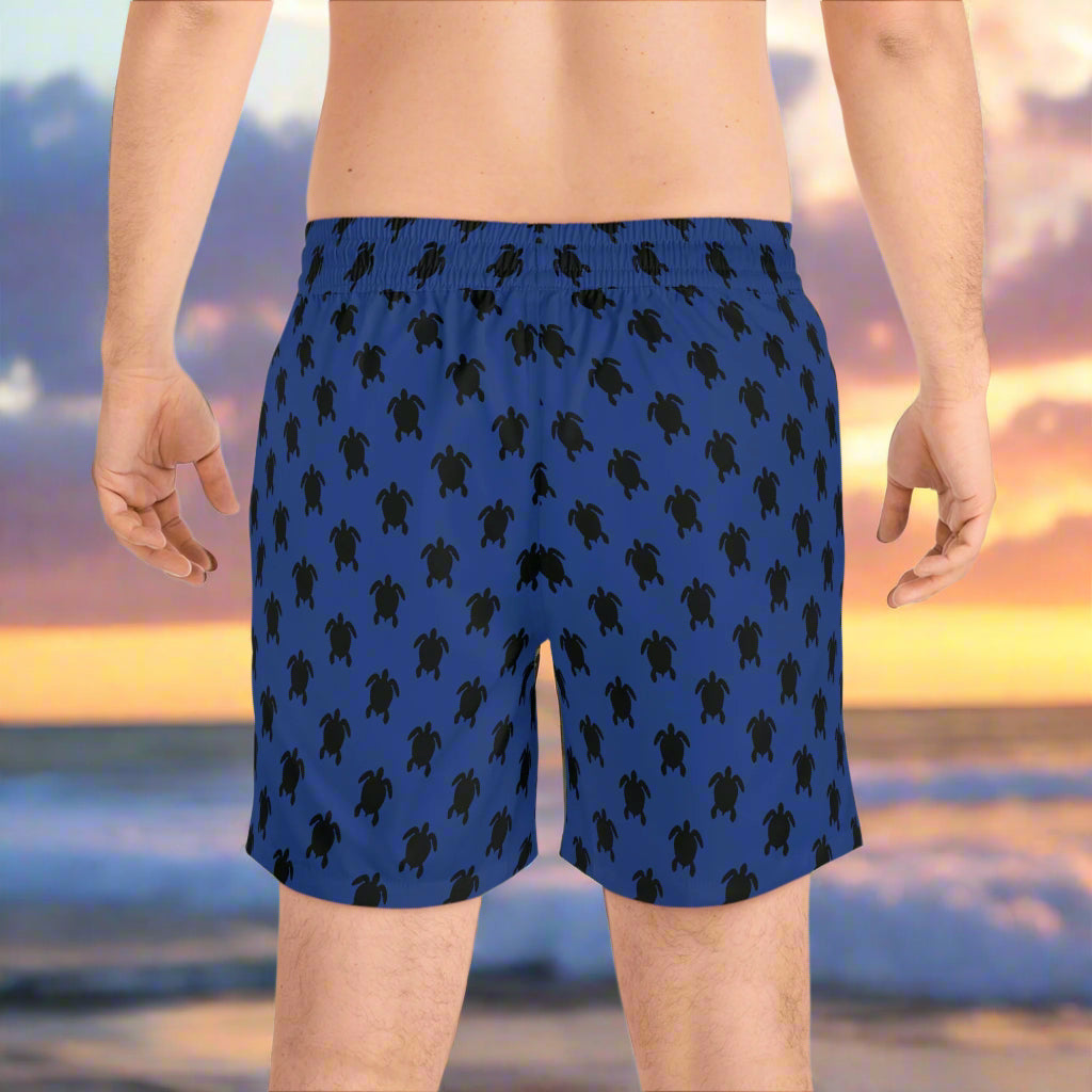 Sea Turtle Board Shorts worn by surfer dude looking out over the ocean as sunset