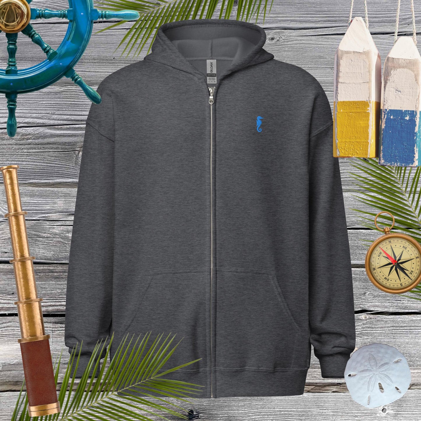 Unisex heavy blend zip hoodie featuring cool embroidered seahorse, perfect for cozy vibes and stylish looks.