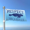 Flag with 'Respect the Locals' text and a seal graphic against a blue sky.