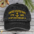 Black cap with 'United States Navy Anniversary text on a wooden surface.