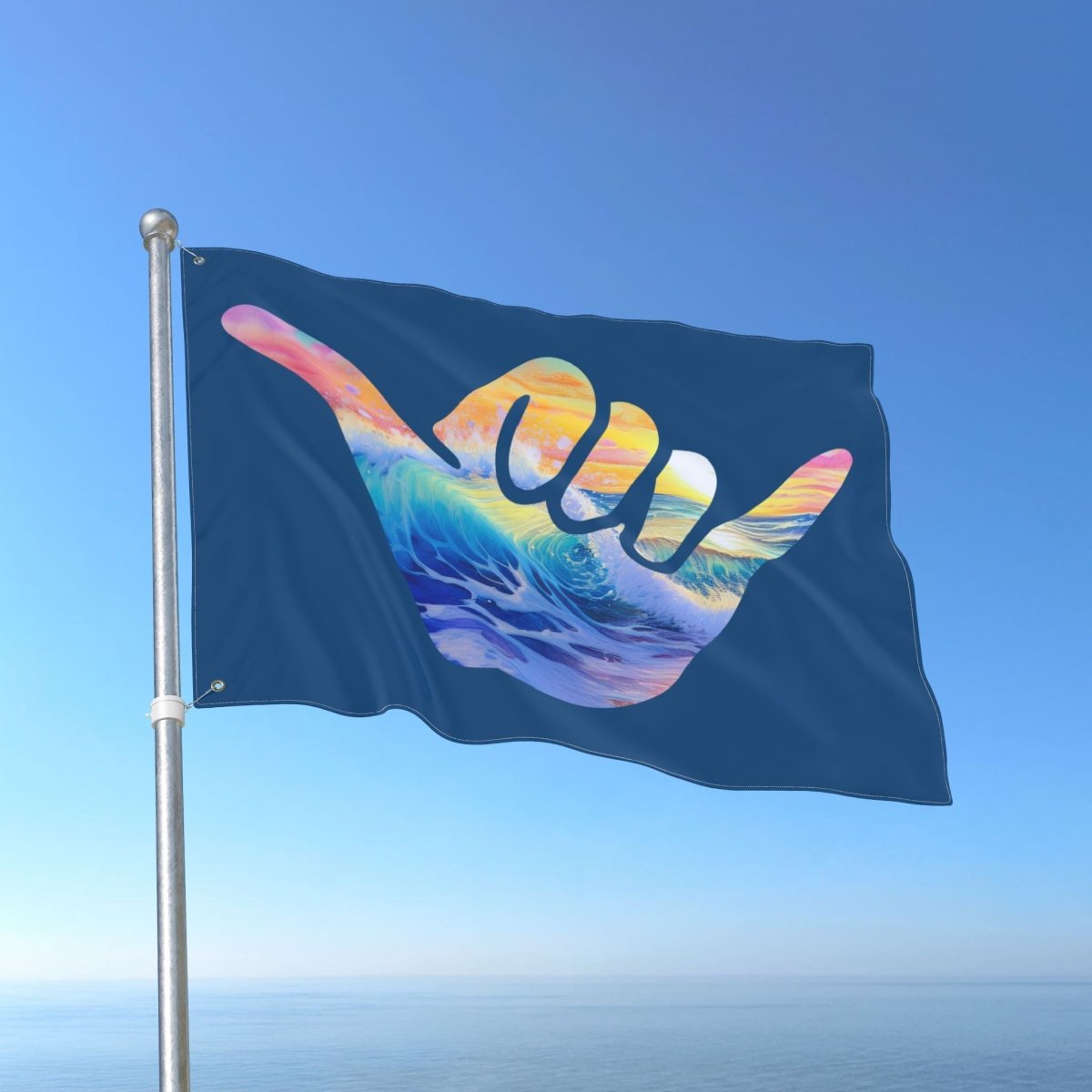 Flag with a colorful wave design and 'shaka' symbol against a clear blue sky.