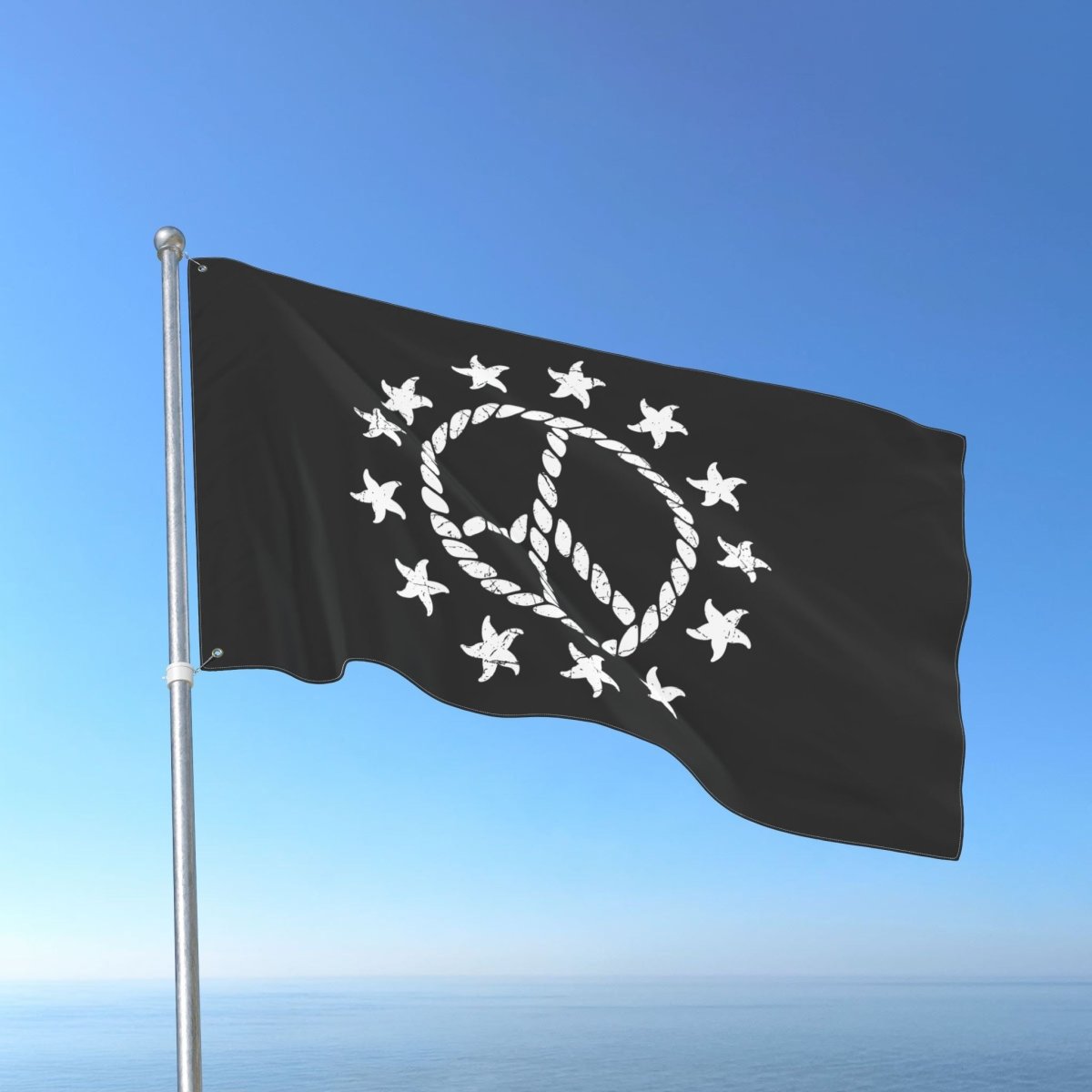 Black flag with white emblem and stars waving against a blue sky