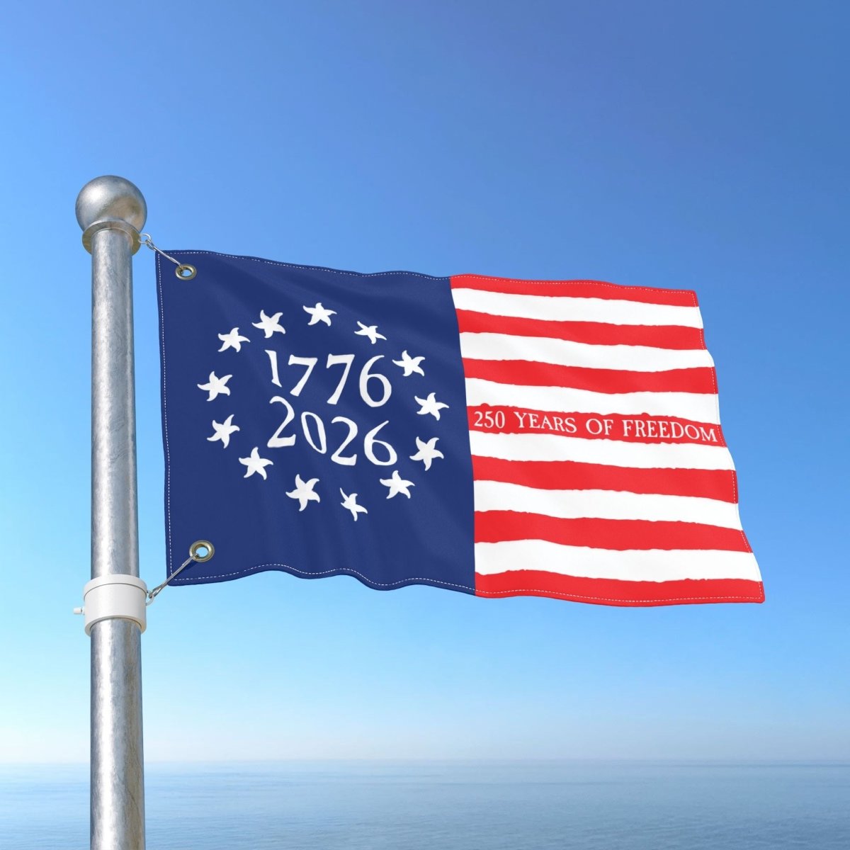 Flag with '1776 2026 250 Years of Freedom' text against a blue sky