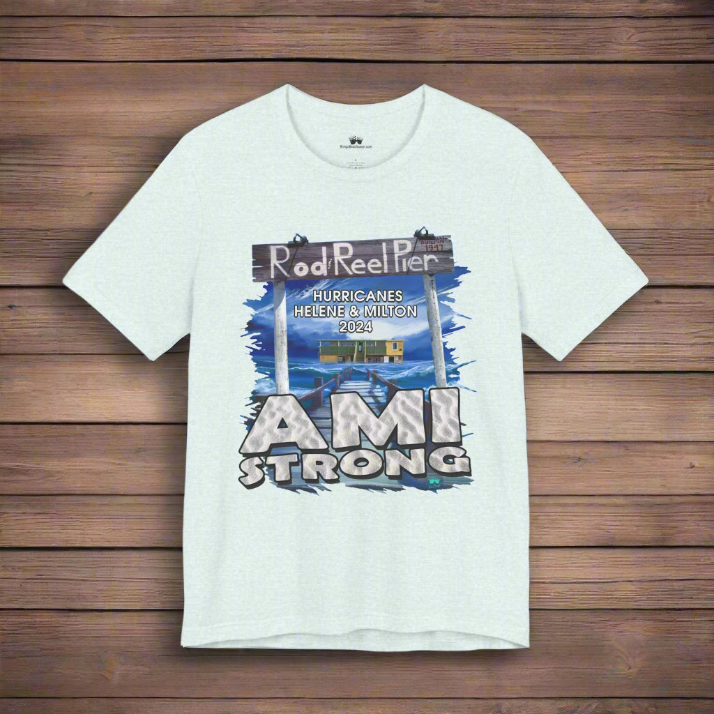 Light blue t-shirt with 'AMI Strong' graphic on a rustic wood background