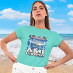 Woman wearing a teal Fundraiser Tee with 'AMI Strong' graphic on a beach