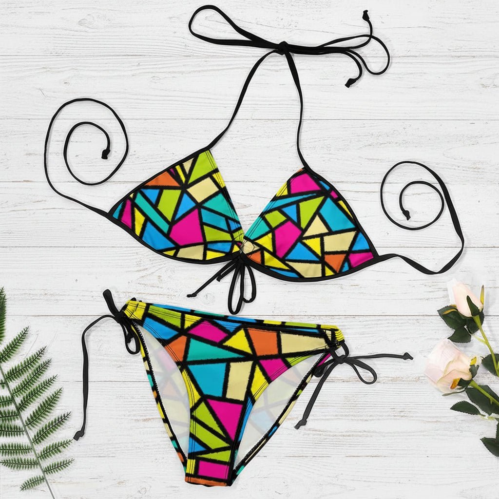 Colorful geometric bikini set on a white background with decorative elements.