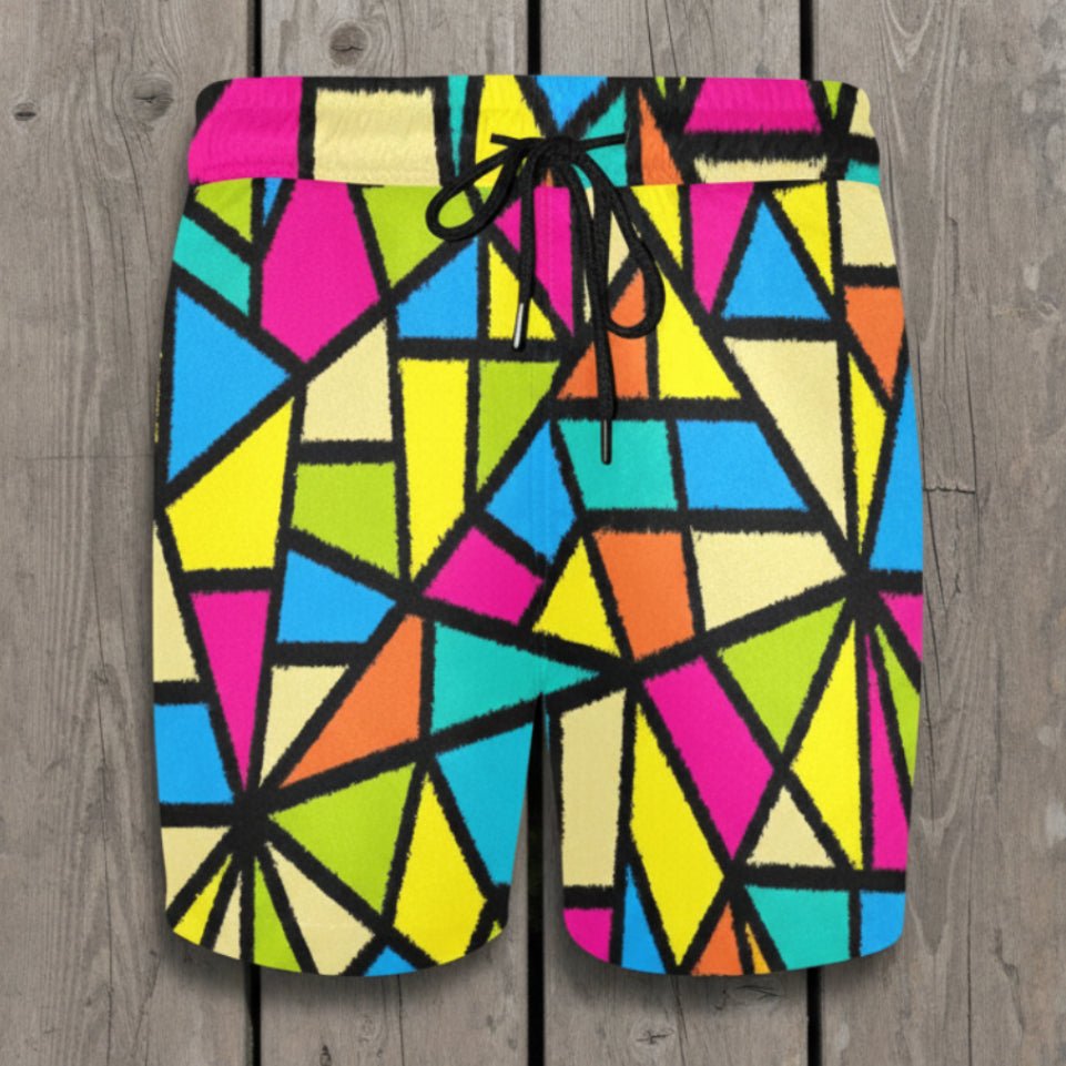 Colorful geometric patterned shorts laying flat on a rustic wood deck