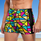 Colorful geometric-patterned swim shorts with a beach background