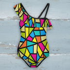 Colorful geometric patterned swimsuit on a nautical wood background