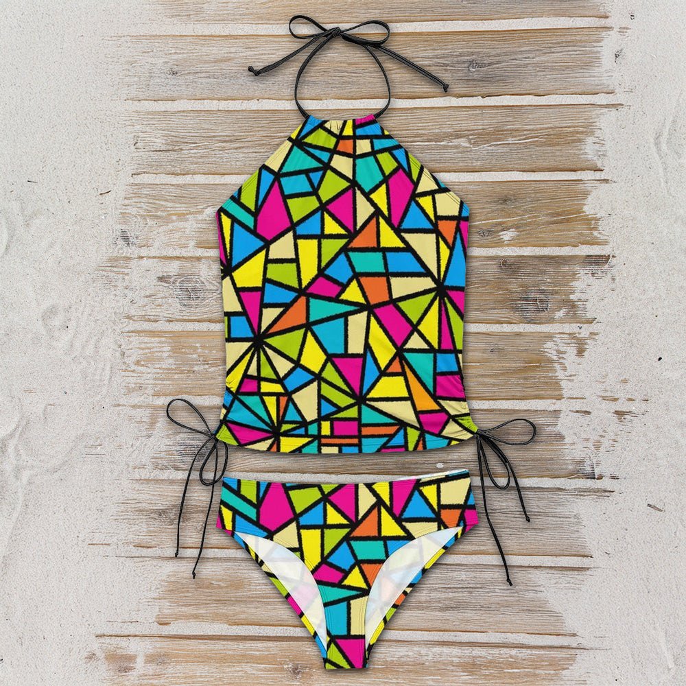 Colorful geometric-patterned bikini set on a wooden surface