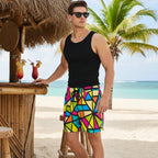 cool dude wearing colorful geometric patterned shorts, sunglasses, and a black tank top is standing at a beachside tiki bar at a tropical island resort.