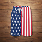 Swim shorts with American flag design on a nautical wood background