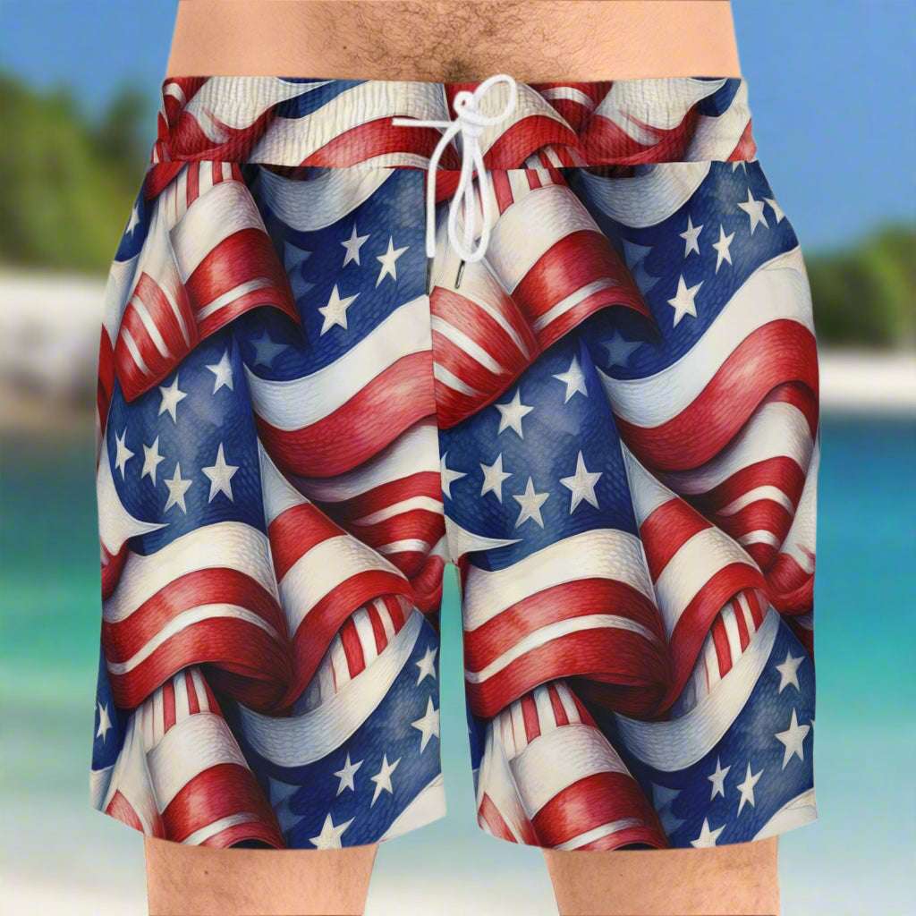 guy celebrating 4th of July on the beach wearing the American flag pattern print by Bongo Beachwear. 