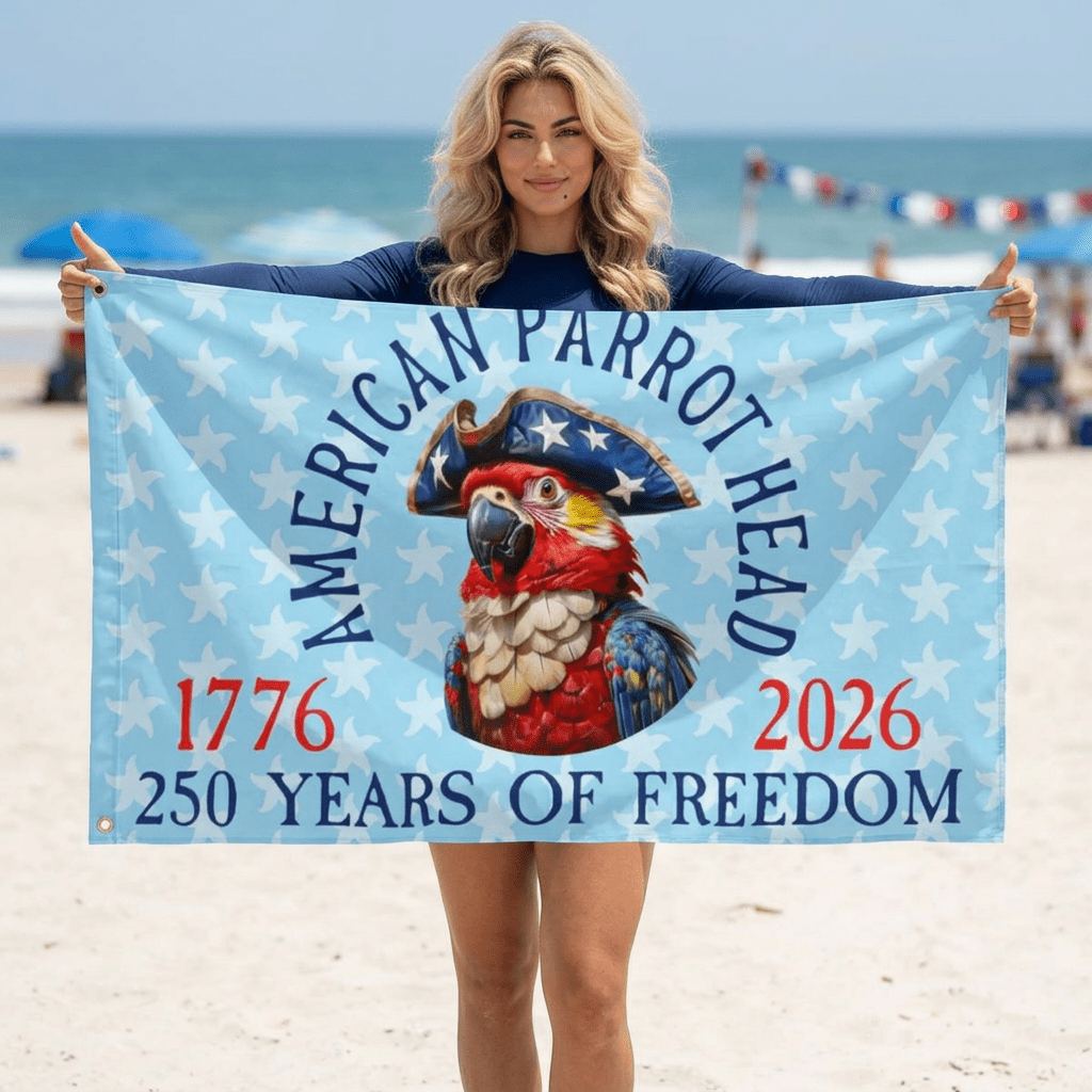 Person holding a flag with a parrot design on a beach