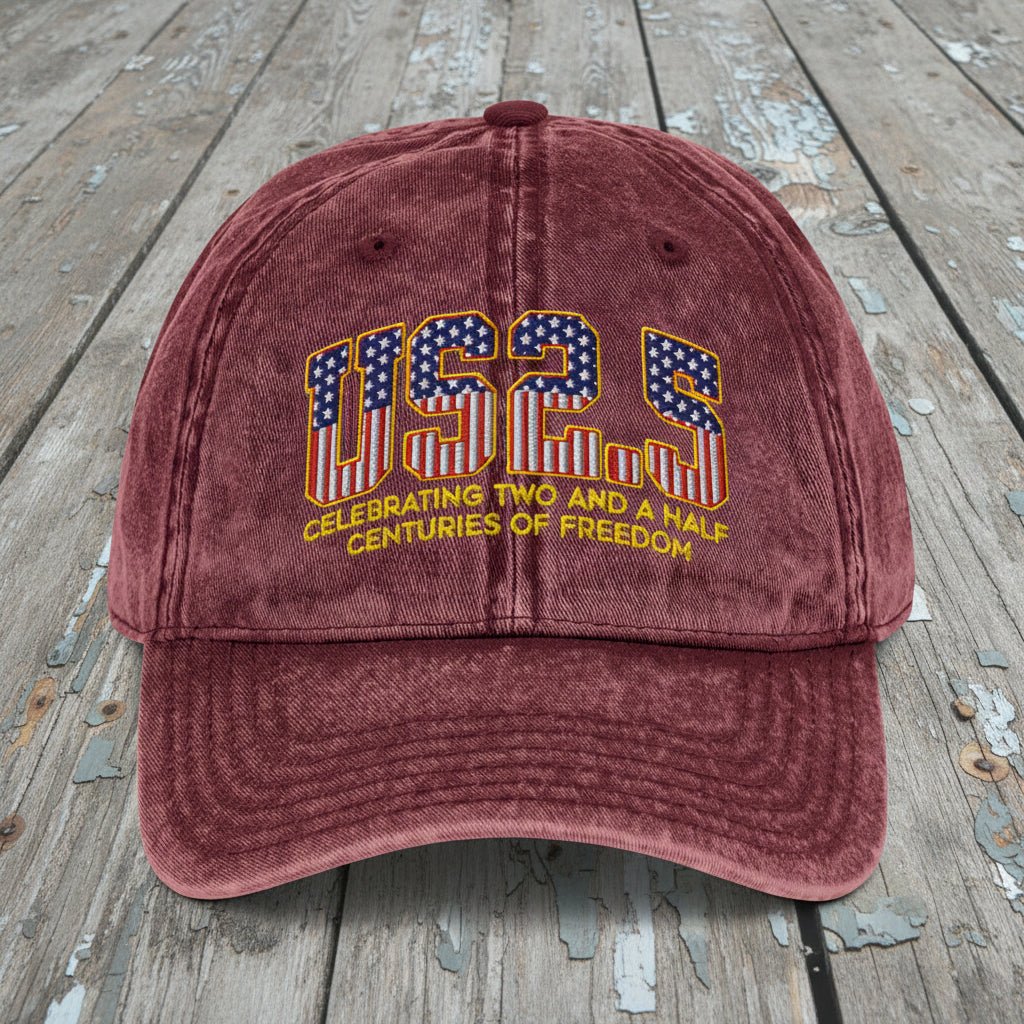 Maroon cap with 'US25' design on a wooden surface
