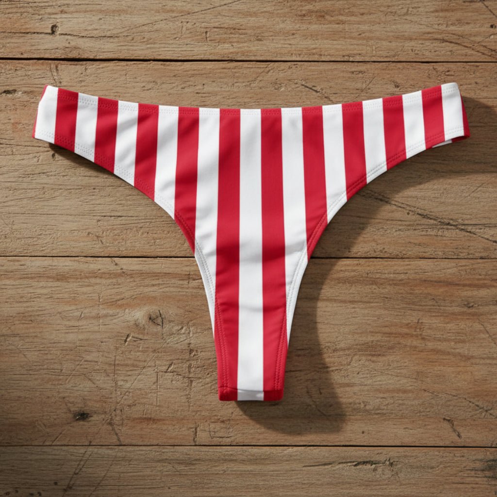 Red and white striped bikini bottom on a rustic wood background