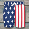 Swim shorts with American flag design on a rustic wood background