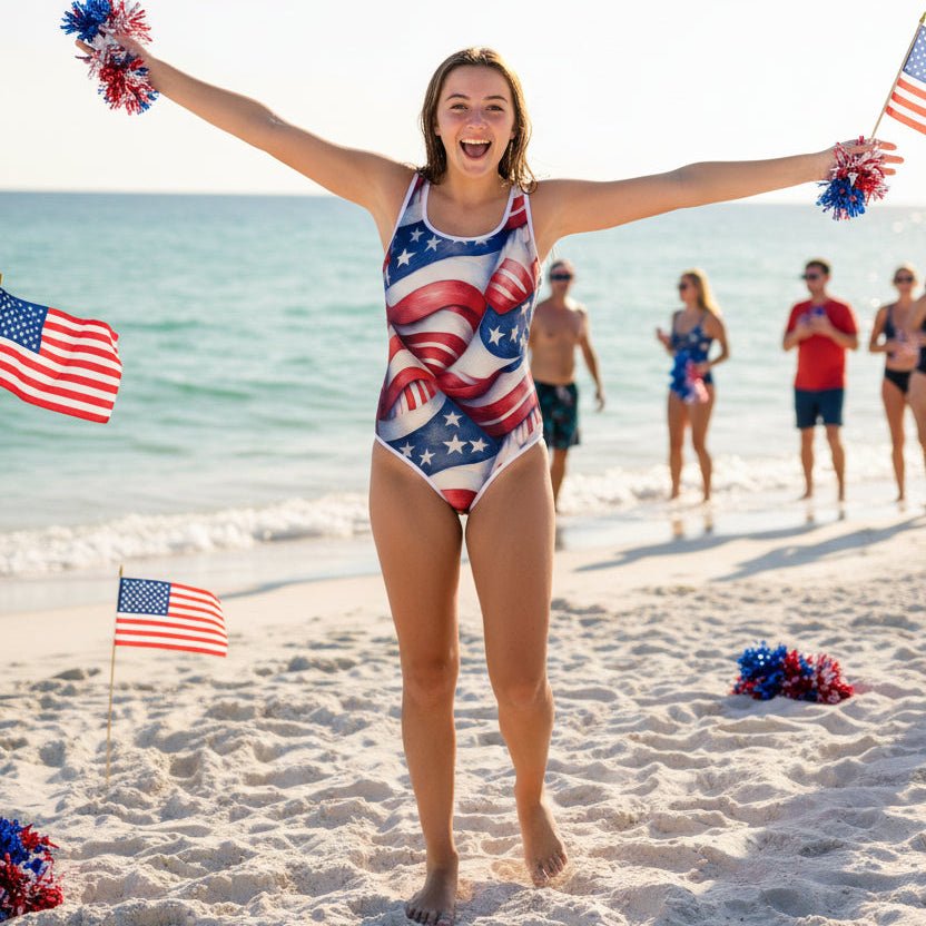 teen girl in a patriotic swimsuit on a beach with American flags