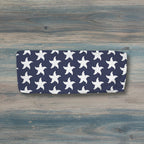 Navy bandeau top with white starfish pattern on a nautical wood background
