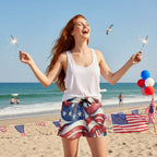 Beautiful woman with long flowing red hair celebrating Independence day on Daytona Beach wearing American flag patterned shorts