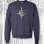 Navy blue sweatshirt with a colorful nautical compass design on a wooden background
