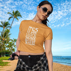 Woman wearing a mustard yellow t-shirt with 'It's 5 o'clock somewhere' text on a beach.