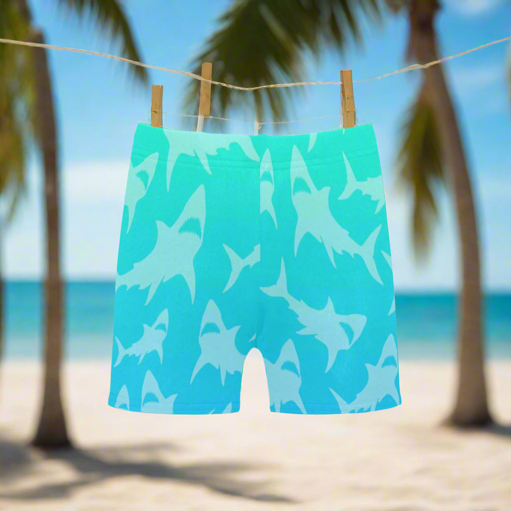 Aqua-Blue swim shorts with cool shark pattern hanging on a line at the beach in Key West