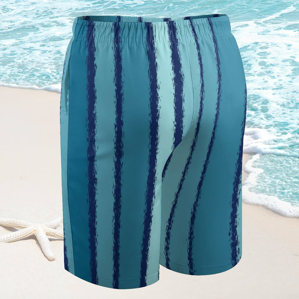 Blue striped shorts on a beach with ocean waves in the background