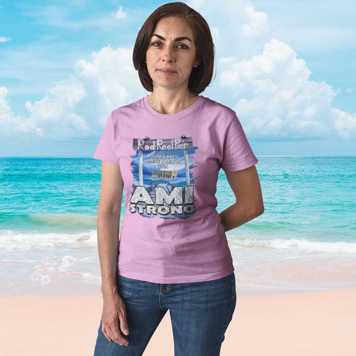 Woman wearing a pink 'AMI Strong' t-shirt on a beach