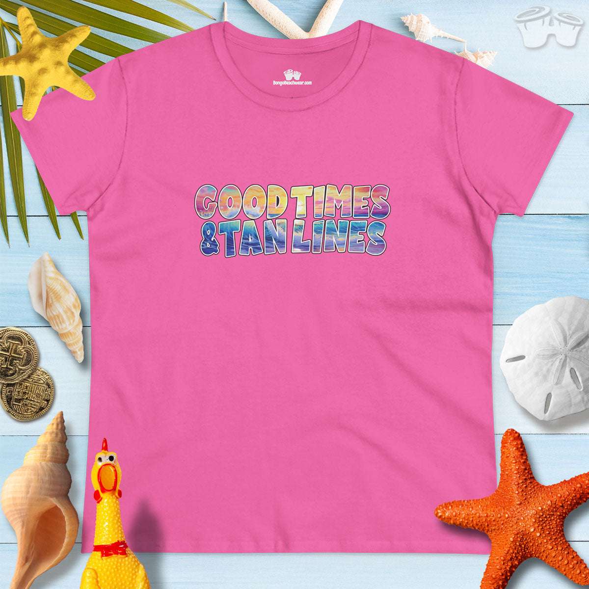 Good Times & Tan Lines pink women's beach lover t-shirt against a tropical beach background.